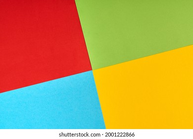 Papers in colors of famous computer corporation, software manufacturer logo. Red, green, blue, yellow paper colours. Corporation logo concept. Abstract background.