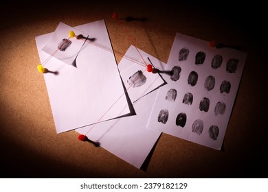 The papers are connected with threads on the board