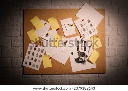 The papers are connected with threads on the board