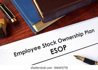 Papers with Employee Stock Ownership Plan (ESOP) on a table.