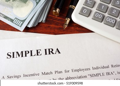 Papers With Simple Ira And Book On A Table.