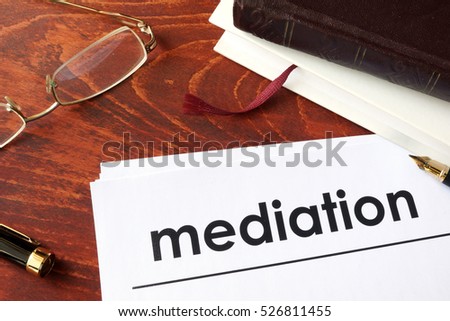 Papers with title mediation on a table.