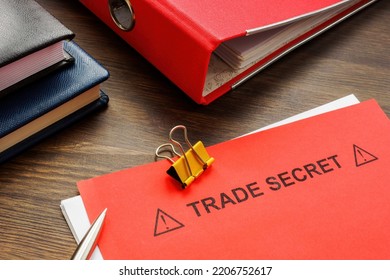 Papers With Trade Secret And A Red Folder.