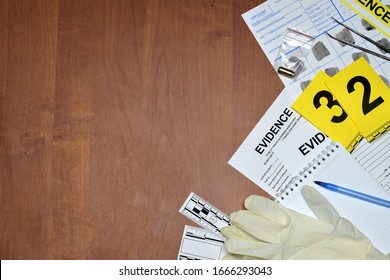Paperwork during crime scene investigation process in csi laboratory. Evidence labels with fingerprint applicant and rubber gloves on vooden table close up