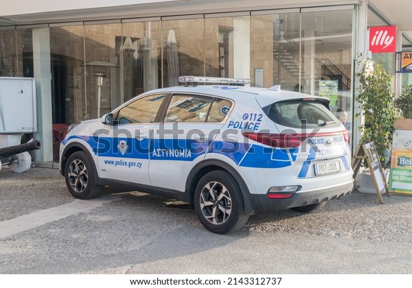 Paphos, Cyprus - April\
2, 2022: Kia sportage of Cyprus police. White and blue Cyprus\
police car (also called a police cruiser, police interceptor,\
patrol car, cop car).