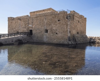 Paphos Fort in Cyprus, perched by the water's edge, surrounded by rocky shores, offering a stunning view of the Mediterranean Sea and the fort’s ancient stone structure. - Powered by Shutterstock