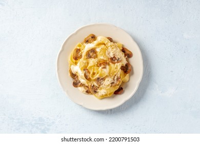 Pappardelle Pasta With Mushrooms, Cream Sauce And Grated Parmesan Cheese, Overhead Flat Lay Shot