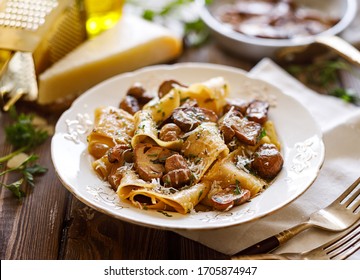 Pappardelle pasta with porcini mushrooms sprinkled with parmesan cheese and chopped parsley, close up  - Shutterstock ID 1705874947