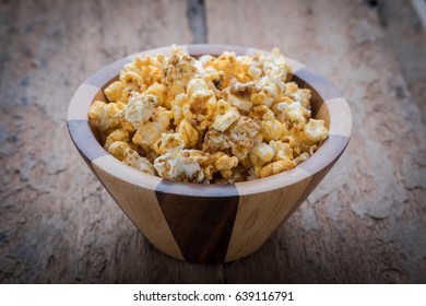 Paprika Popcorn In A Bowl On The Wooden Table.