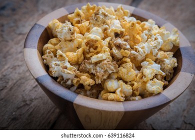 Paprika Popcorn In A Bowl On The Wooden Table.
