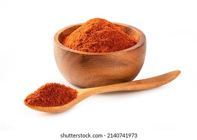 Paprika powder ( bell pepper) in wooden bowl and spoon isolated on white background. - Shutterstock ID 2140741973