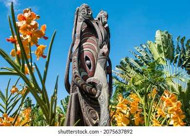 Papua Mask In With Yellow Orchids In A Garden