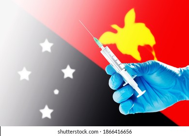 Papua New Guinea Flag Blurred Background Covid-19, Corona, Selective focused on Syringe Injection