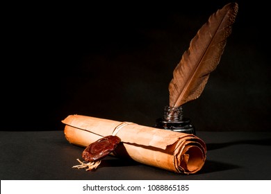 A papyrus scroll with a seal, a feather and an inkwell on a black background
