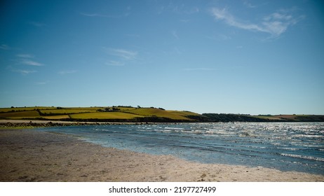 Par Sands Beach with Ocean Waves and Landscape View with Blue Skies Over Cornwall.