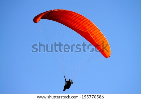 Para glider soaring through the sky