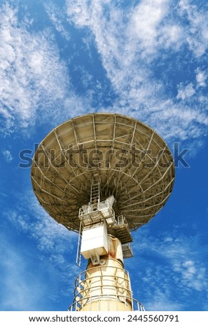 A parabolic antenna under the blue sky