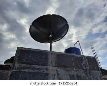 Parabolic Disk And Water Tank On The Roof Top