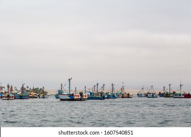 Paracas, Peru - September 12, 2015: Pelicans sitting on a fishing boat anchored in the bay