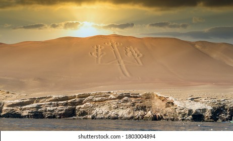 Paracas, Peru - September 2017: Ancient large scale candelabrum figure in Paracas national park during sunset - Shutterstock ID 1803004894