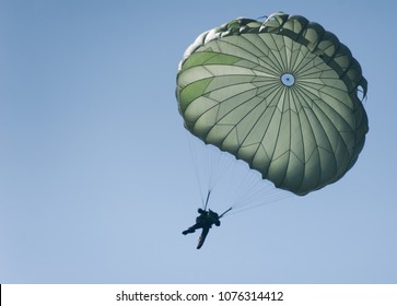 A parachute during a risky operation at sea. A special forces paratrooper jumping from a plane. 