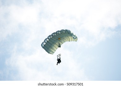 Parachute on white sky background