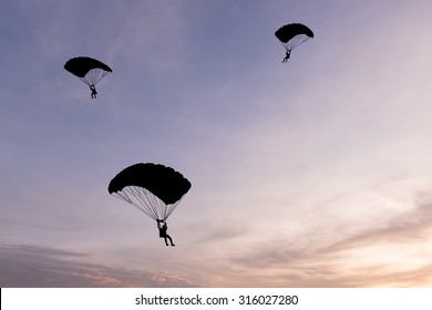 parachute at sunset silhouetted