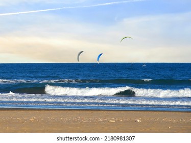Parachute wind surfing water sport in sea. Parachute surfers in sea. Surfing in ocean. Kite Surfing and WindSurfing on waves in sea. Sailing sports on board. Windsurfing sail boarding with Parachute.