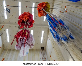 Parachutes Hanging From Ceiling After Being Checked And Waiting For Folding And Packing Prior To Taking Next Fire Jumper Out To Fight A Wildfire.