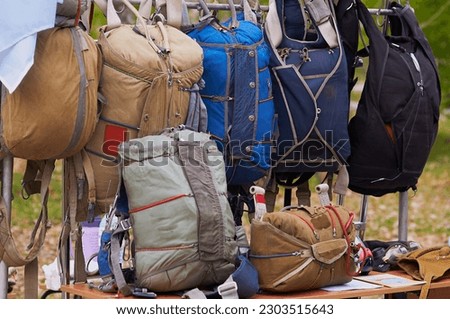 Parachutes of various types are located at the armaments exhibition stand. Parachuting.