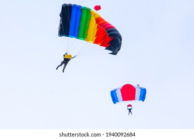 Parachutists Jump From A Military Plane During A Military Exercise. Many Soldiers With Parachutes In The Sky.