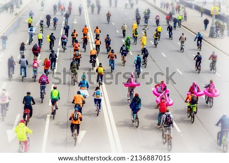 Parade of bicyclists in city. Youth and families with children participate in mass bicycle racing. Selective focus. Concept of modern lifestyle