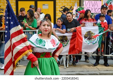 Parade Participant Is Wearing Traditional Mexican Costume And Holding The US Flag During The Annual Mexican Day Parade Along Madison Avenue In New York City On Sept 18, 2022.