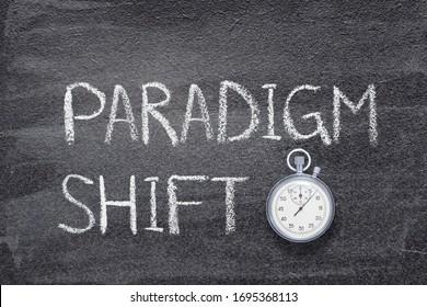 paradigm shift phrase written on chalkboard with vintage precise stopwatch