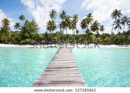 paradise beach with turquoise water, wooden pier and tropical palm trees, summer holidays in Thailand, Koh Kood