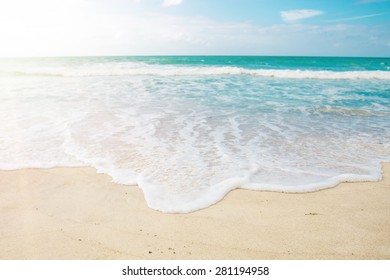 Paradise beach view. White sand, azure blue sea with waves and sun beams Ã¢Â?Â? idyllic summer travel location. Honeymoon exotic vacations in Beau Vallon, Mahe, Seychelles Island in Indian Ocean - Shutterstock ID 281194958