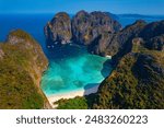 Paradise lagoon Maya Bay, island Ko Phi Phi Leh, Thailand, aerial top view. Amazing travel drone photo of turquoise water and white beach.