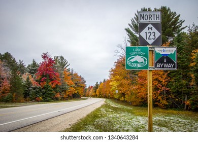 Paradise, Michigan, USA - October 13, 2018: Michigan Scenic Byway With Lake Superior Scenic Circle Tour Sign On A Rural Michigan Two Lane Highway Surrounded By Fall Color