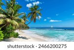 Paradise sandy beach with palm trees and a sailing boat in the turquoise sea on Paradise island.