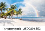 Paradise Sunny beach with palms and turquoise sea. Amazing rainbow in the background Summer vacation and tropical beach concept - Cancun, Mexico