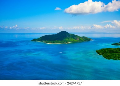 Paradise Tropical Island From Above - Aerial. Calm Exotic Beach Resort In Background