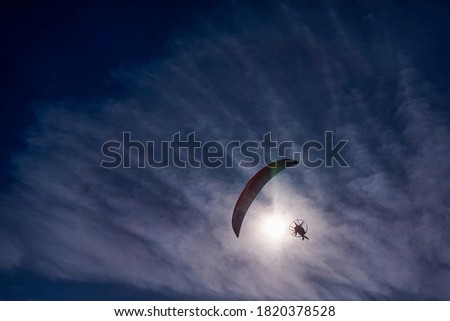 Paraglider in the blue sky