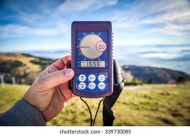 Paraglider Is Checking Digital Altimeter For Paragliding Or Parachute Before The Start On The Slope