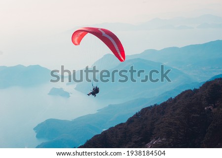 Paraglider flying on Oludeniz beach in Fethiye, Mugla. Travel destination. Summer and holiday concept.