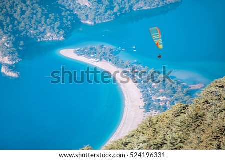 Paraglider flying over Babadag on the background of oludeniz beach.