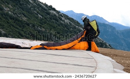 Paraglider prepares for extreme jumping from a hill. Paragliding parachute extreme sport. Babadag peak, Turkey. High quality photo