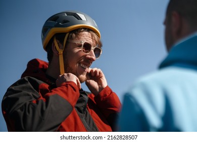 Paraglider is preparing for flight, putting on helmet. - Powered by Shutterstock