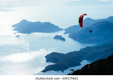 Paraglider silhouette flying in the sky over the sea.Paragliding. - Shutterstock ID 639179641