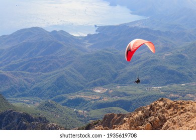 Paragliders flying from a top of Tahtali mountain near Kemer, Antalya Province in Turkey. Concept of active lifestyle and extreme sport adventure