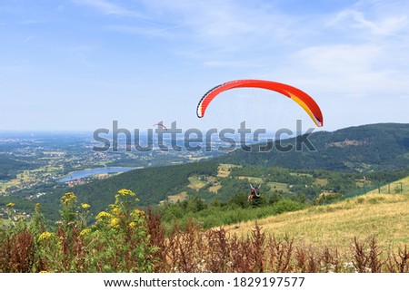 Paragliders start their flight on Zar mountain near Zywiec in southern Poland